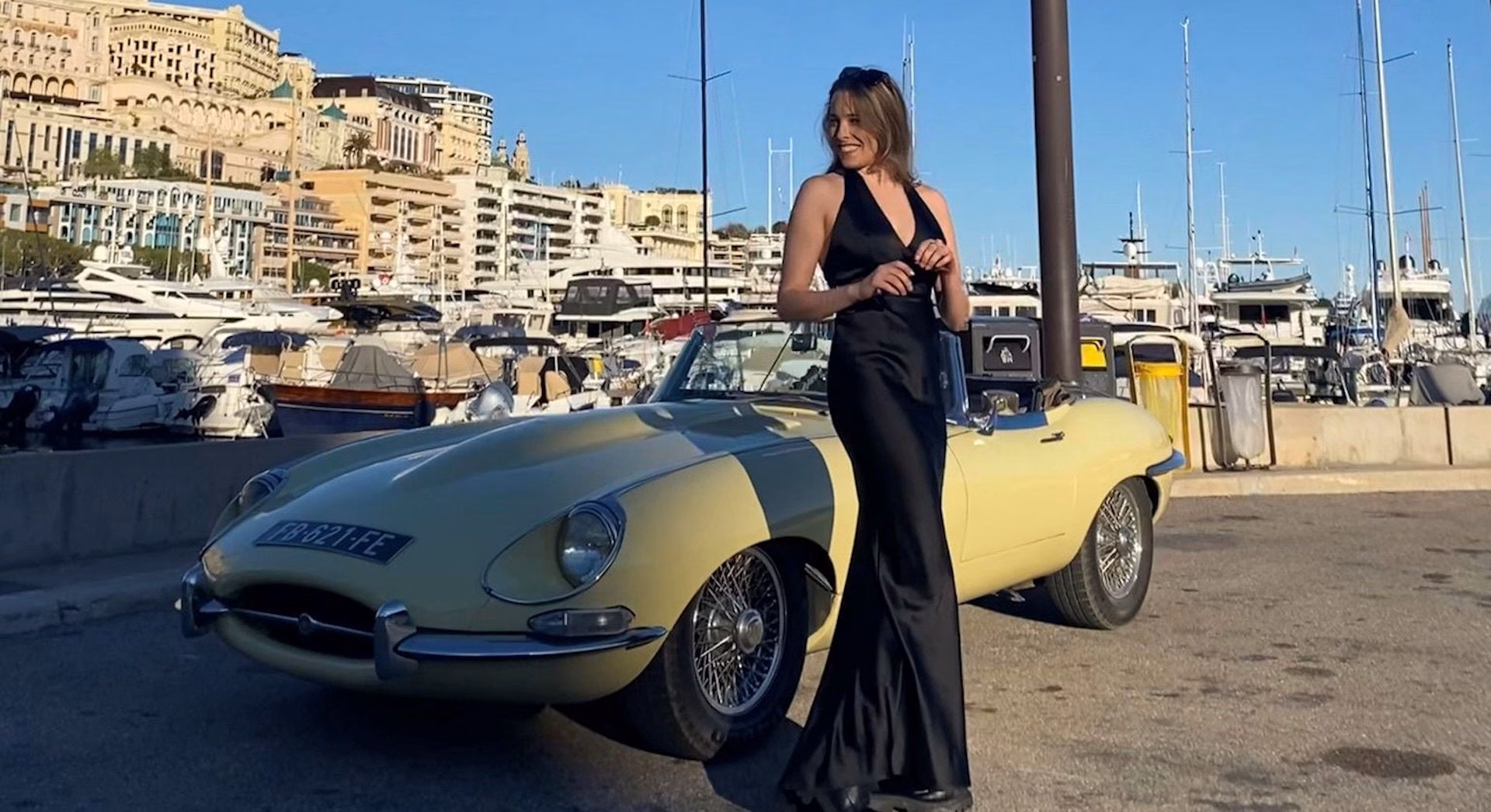 Image of elegant young lady in front of a sports car