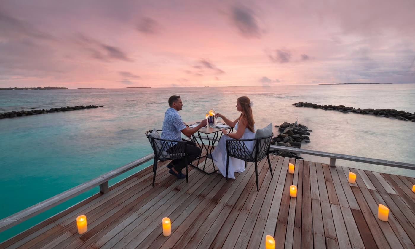 Image shows a couple enjoying gallery dining at Amilla Maldives Resort